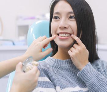 Patient discussing dental implant treatment with a dentist